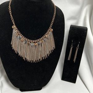 Triple metal toned necklace and earrings.
